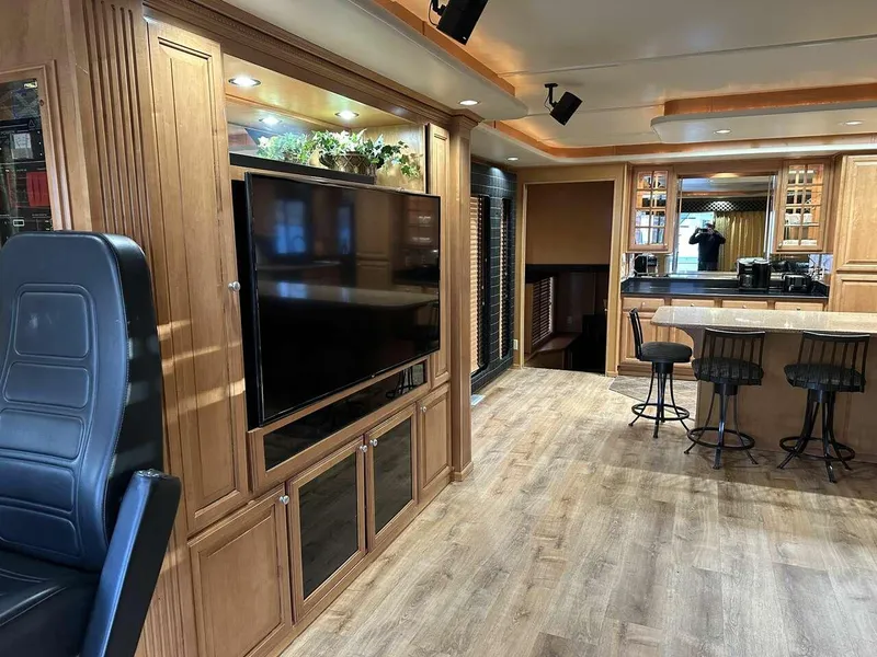 Slide: The Image of Luxurious 2005 Sumerset Top Hat interior with wood cabinetry, flat-screen TV, and bar seating. - 4