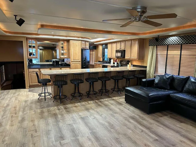 Slide: The Image of Luxurious 2005 Sumerset Top Hat interior with modern kitchen, bar seating, and cozy living area. - 5