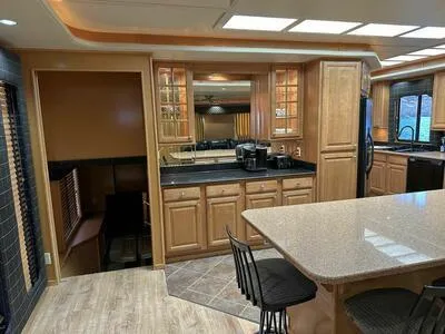 Slide: The Image of Luxurious 2005 Sumerset Top Hat kitchen with wooden cabinets and modern appliances. - 8
