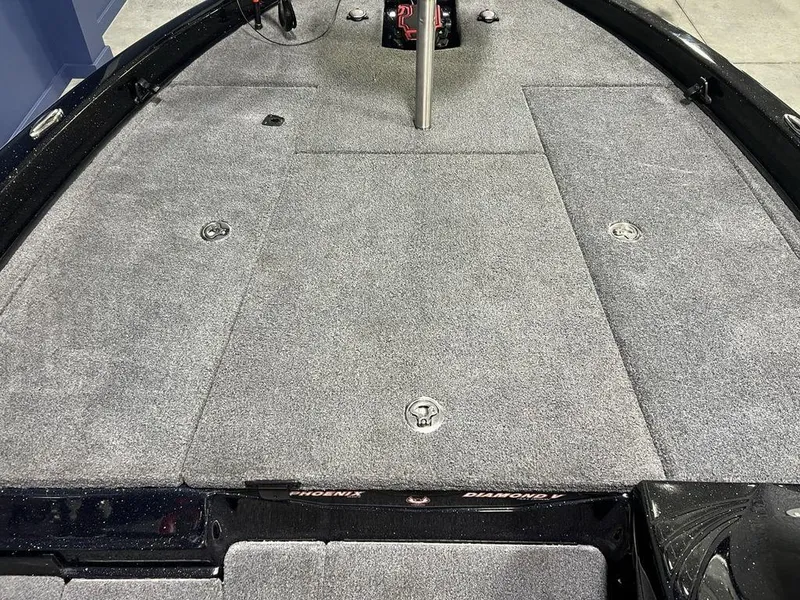 Slide: The Image of 2022 Phoenix 919 Pro XP boat deck with gray carpet and storage compartments. - 10