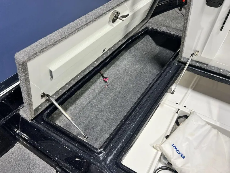 Slide: The Image of 2022 Phoenix 919 Pro XP boat storage compartment with open lid and hydraulic struts. - 11