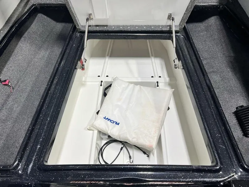 Slide: The Image of 2022 Phoenix 919 Pro XP storage compartment with white bag and cables. - 13