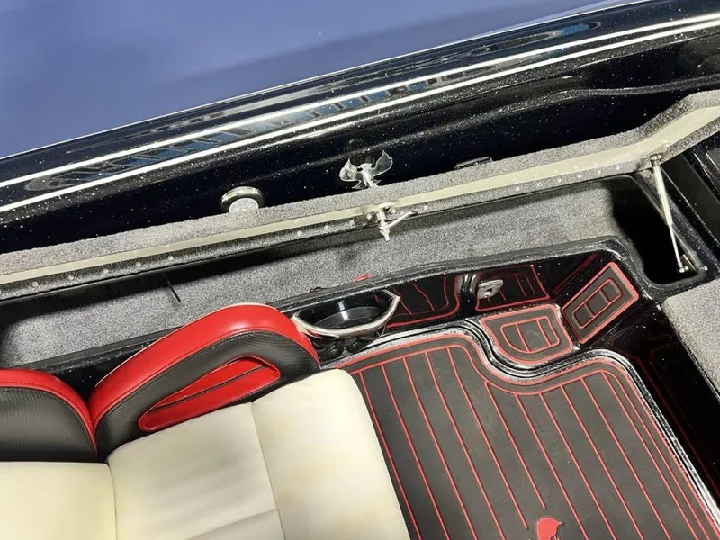 Slide: The Image of 2022 Phoenix 919 Pro XP interior with red and black accents, featuring a cup holder. - 20