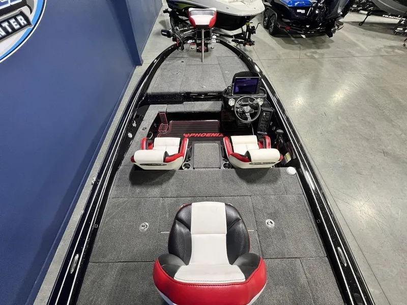 Slide: The Image of 2022 Phoenix 919 Pro XP boat interior with red and white seating, steering console, and carpeted deck. - 22