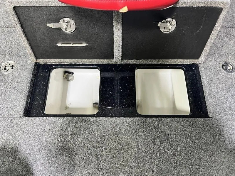 Slide: The Image of Phoenix 919 Pro XP 2022 boat storage compartments with secure locks and carpeted finish. - 24
