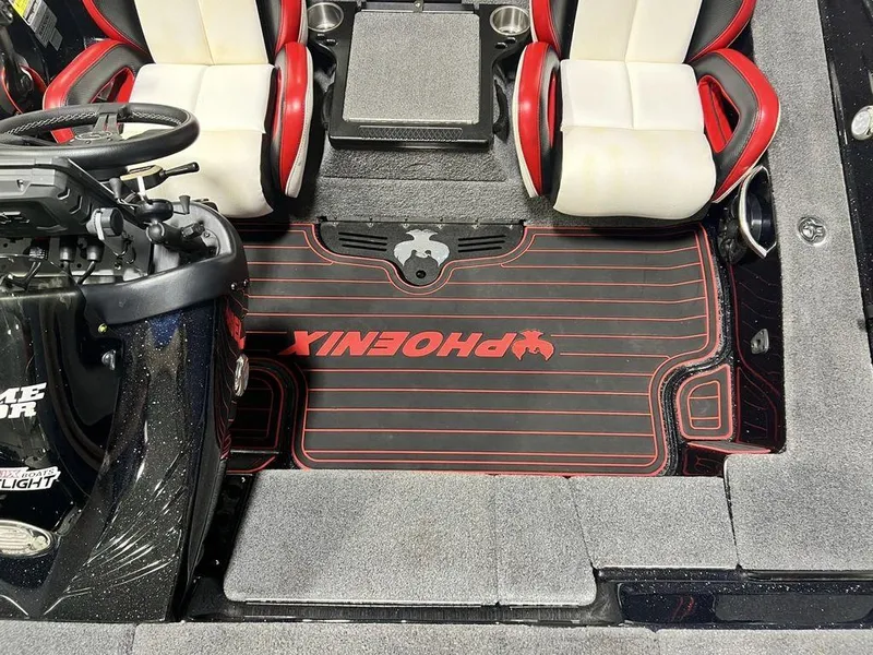 Slide: The Image of 2022 Phoenix 919 Pro XP boat interior with red and white seats and branded floor mat. - 25