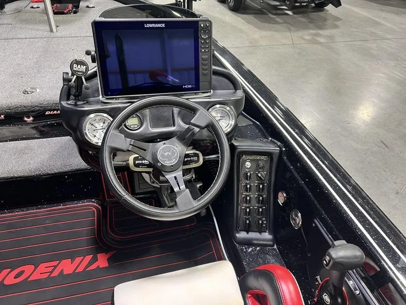 Slide: The Image of 2022 Phoenix 919 Pro XP boat dashboard with steering wheel and electronic display. - 28