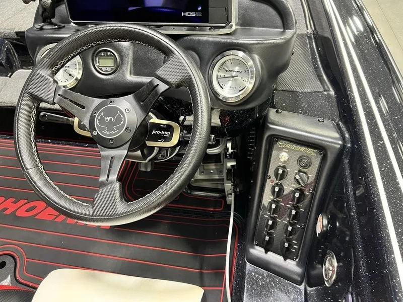 Slide: The Image of 2022 Phoenix 919 Pro XP boat dashboard with steering wheel and control panel. - 29