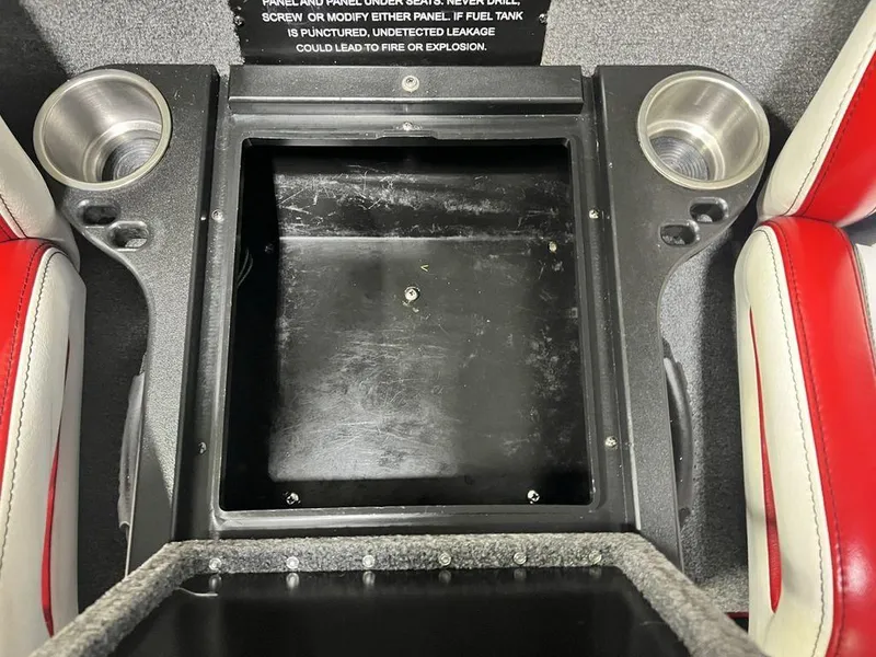 Slide: The Image of 2022 Phoenix 919 Pro XP boat interior with cup holders and storage compartment. - 31