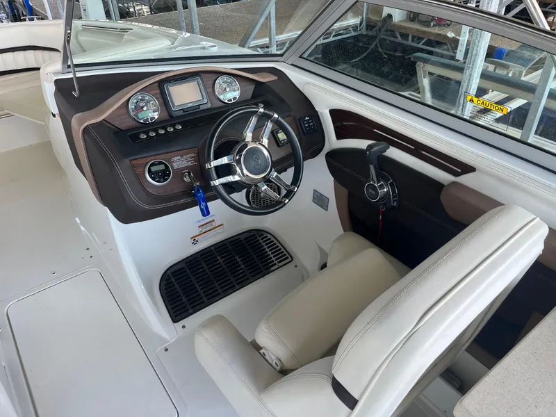 Slide: The Image of 2013 Cobalt A28 boat cockpit with steering wheel and control panel. - 10