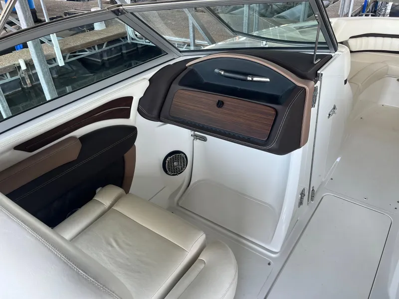 Slide: The Image of 2013 Cobalt A28 boat interior with leather seating and dashboard. - 11
