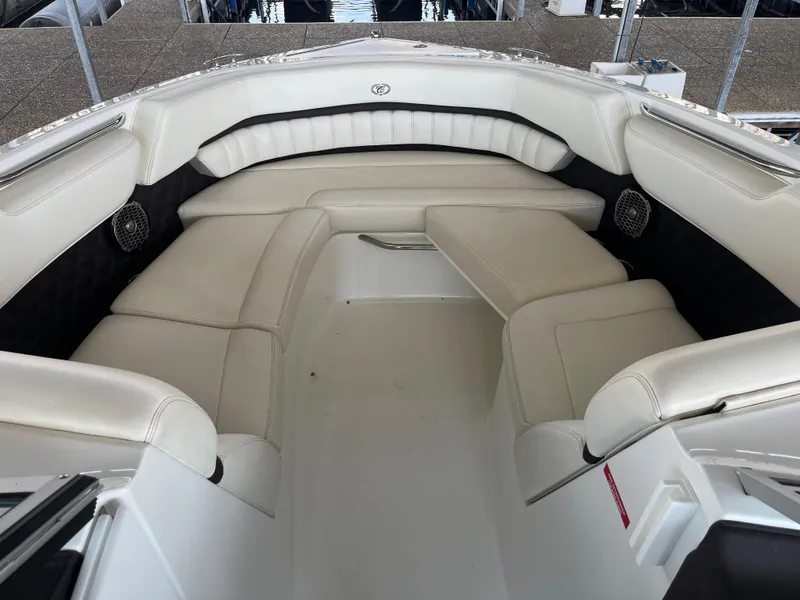 Slide: The Image of 2013 Cobalt A28 boat with spacious white leather seating in the bow area. - 12