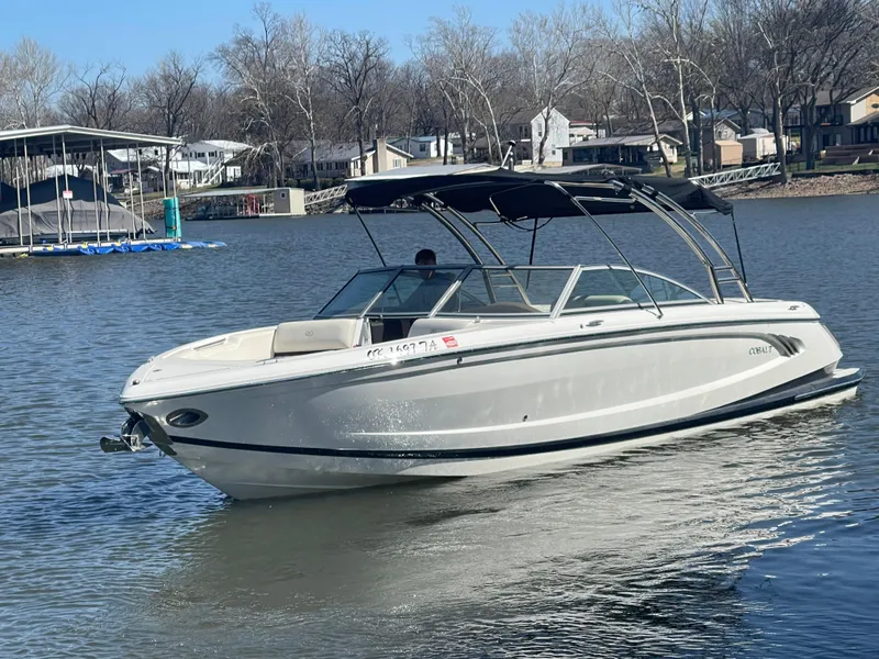 Slide: The Image of 2013 Cobalt A28 boat on a calm lake with houses in the background. - 5