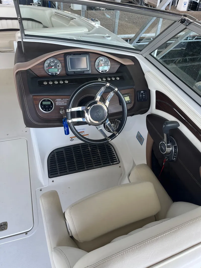 Slide: The Image of 2013 Cobalt A28 boat cockpit with steering wheel and control panel. - 9