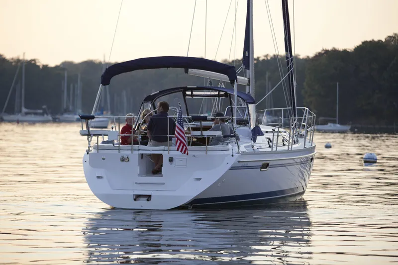 Slide: The Image of 2024 Catalina 355 sailboat cruising on a calm lake at sunset. - 10