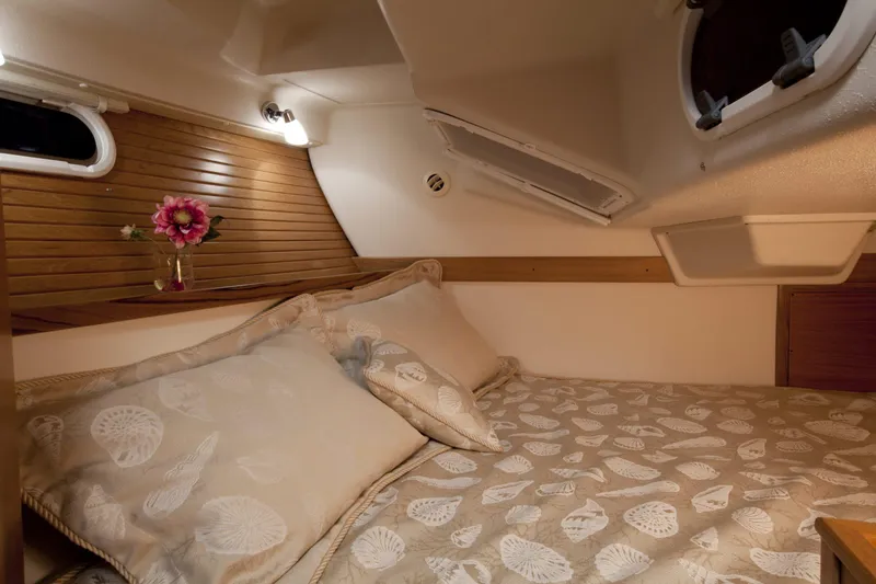 Slide: The Image of 2024 Catalina 355 yacht interior cabin with cozy bed and floral decor. - 8