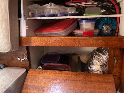 Slide: The Image of Storage compartments with containers in a 1969 Spencer 44 CC boat. - 12