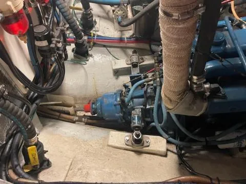 Slide: The Image of Engine compartment of a 1969 Spencer 44 CC boat with visible wiring and components. - 2