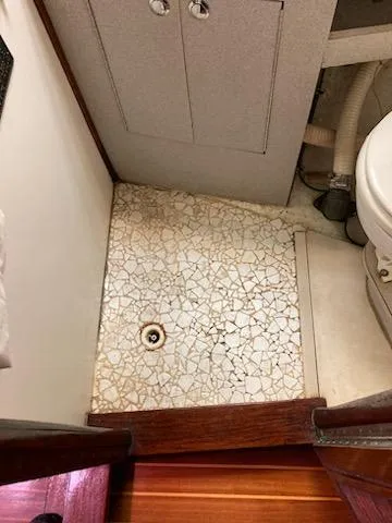 Slide: The Image of 1969 Spencer 44 CC boat bathroom with mosaic tile floor and compact toilet. - 21