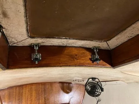 Slide: The Image of Interior view of 1969 Spencer 44 CC sailboat showing wooden cabinetry and hardware. - 28