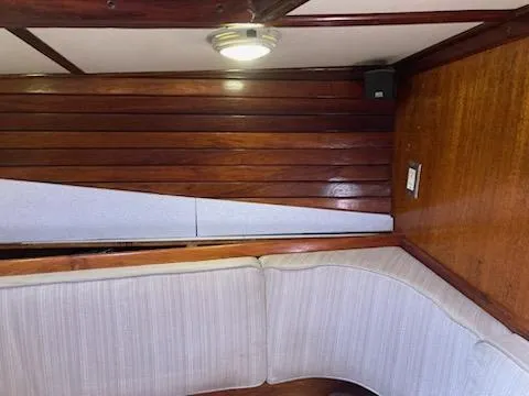 Slide: The Image of Interior of 1969 Spencer 44 CC sailboat with wooden paneling and cushioned seating. - 29