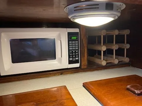 Slide: The Image of Microwave and wine rack in the kitchen of a 1969 Spencer 44 CC boat. - 30