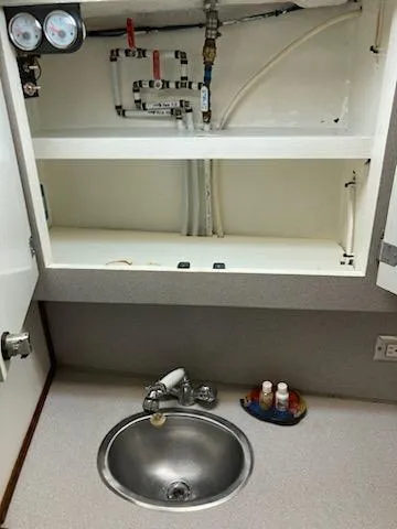 Slide: The Image of 1969 Spencer 44 CC boat sink area with plumbing and storage compartments. - 31