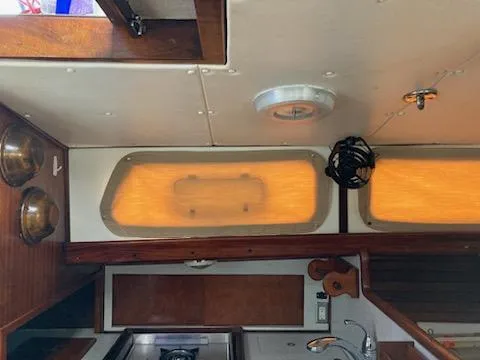 Slide: The Image of Interior of a 1969 Spencer 44 CC sailboat with wooden cabinetry and portholes. - 34