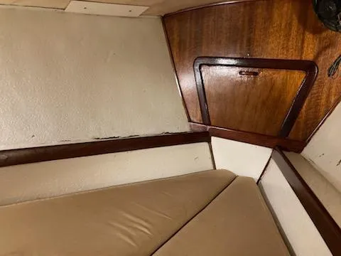 Slide: The Image of Interior cabin of 1969 Spencer 44 CC sailboat with wooden paneling and beige cushions. - 35