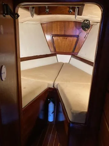 Slide: The Image of 1969 Spencer 44 CC sailboat cabin with V-berth and wooden interior. - 36