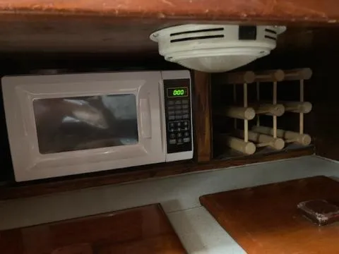 Slide: The Image of Microwave and spice rack in the galley of a 1969 Spencer 44 CC sailboat. - 41