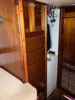 Slide: The Image of Interior of a 1969 Spencer 44 CC sailboat with wooden cabinetry. - 44