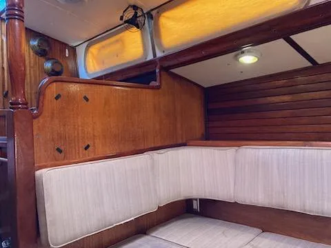 Slide: The Image of Interior of 1969 Spencer 44 CC sailboat with wooden paneling and cushioned seating. - 8