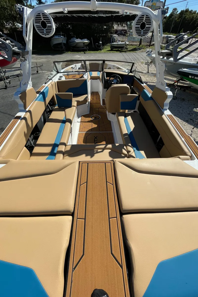 Slide: The Image of 2024 ATX Surf Boats 24 Type-S interior, tan and blue seating, open deck layout. - 11