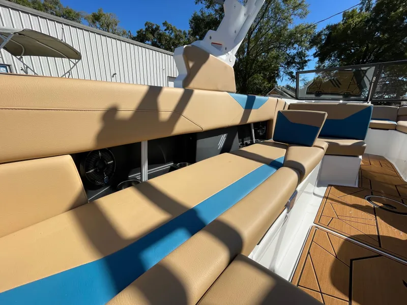 Slide: The Image of Interior seating of 2024 ATX Surf Boats 24 Type-S with tan and blue upholstery. - 2