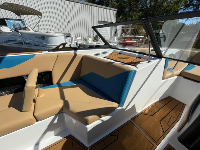 Slide: The Image of 2024 ATX Surf Boats 24 Type-S interior with tan and blue seating. - 4