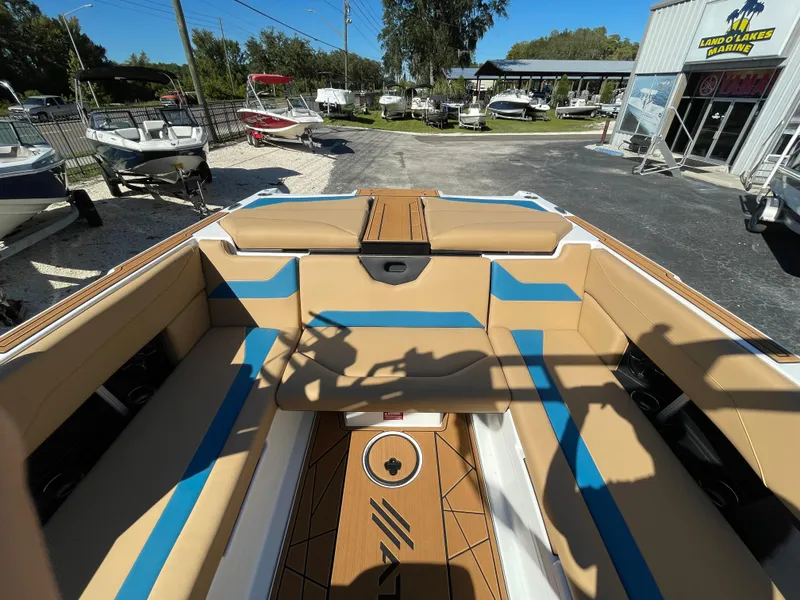 Slide: The Image of 2024 ATX Surf Boats 24 Type-S interior with tan and blue seating. - 6