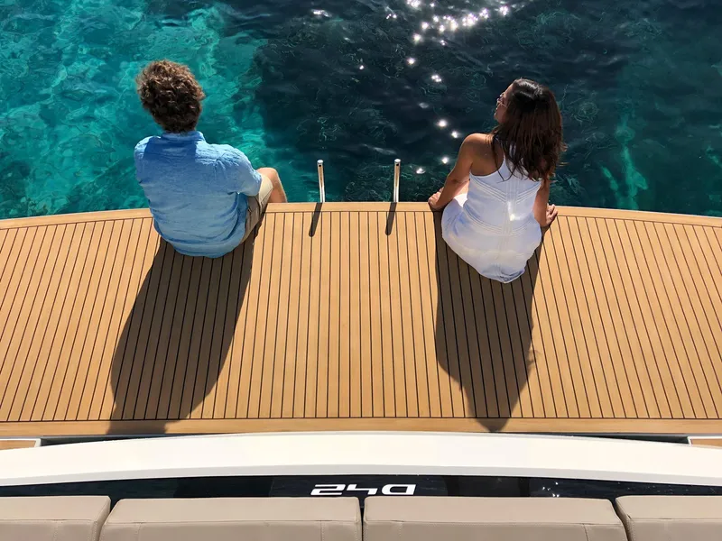 Slide: The Image of Two people relaxing on the deck of a 2024 De Antonio Yachts D42 Open. - 12