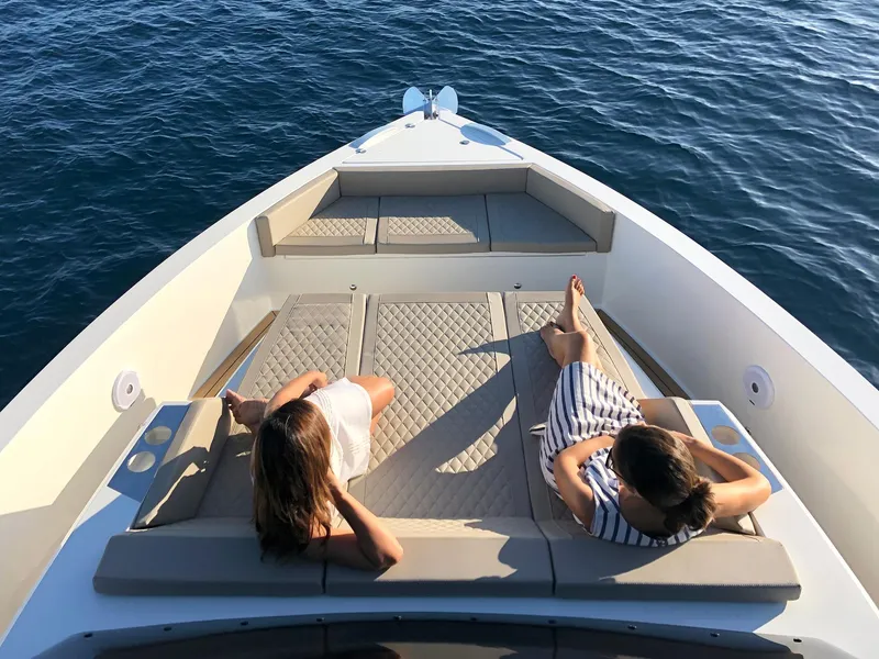 Slide: The Image of Two people relaxing on the deck of a 2024 De Antonio Yachts D42 Open. - 14