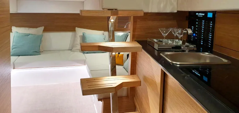 Slide: The Image of 2024 De Antonio Yachts D42 Open interior with modern kitchen and cozy seating area. - 8