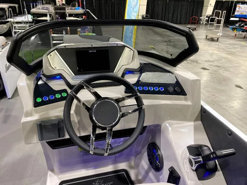 Slide: The Image of 2024 SunChaser Calais 23 SB DC boat dashboard with steering wheel and control panel. - 5