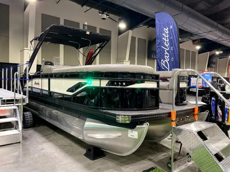 The Image of 2024 Barletta Corsa Ultra-Lounge 25UCA pontoon boat on display indoors. - 1