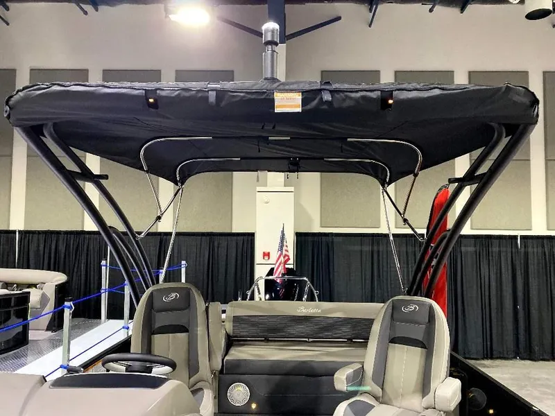 Slide: The Image of 2024 Barletta Corsa Ultra-Lounge 25UCA boat interior with canopy at indoor display. - 16