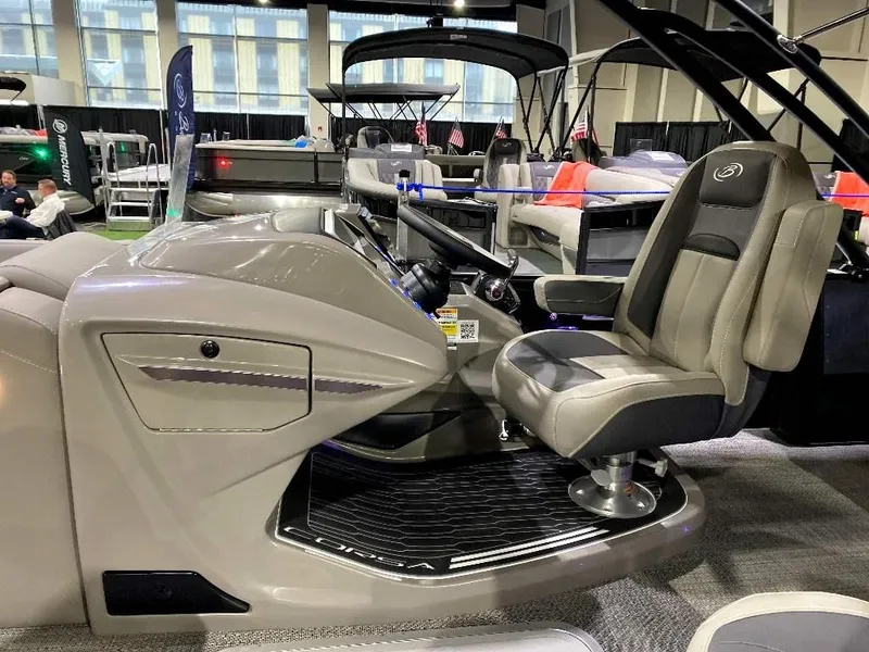 Slide: The Image of 2024 Barletta Corsa Ultra-Lounge 25UCA boat interior with captain's chair and control console. - 19