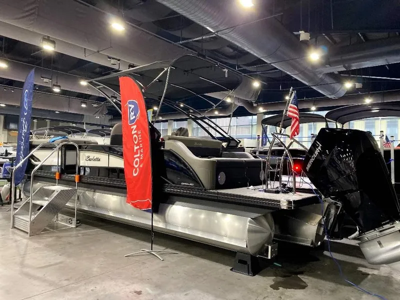 Slide: The Image of 2024 Barletta Corsa Ultra-Lounge 25UCA pontoon boat on display indoors. - 3