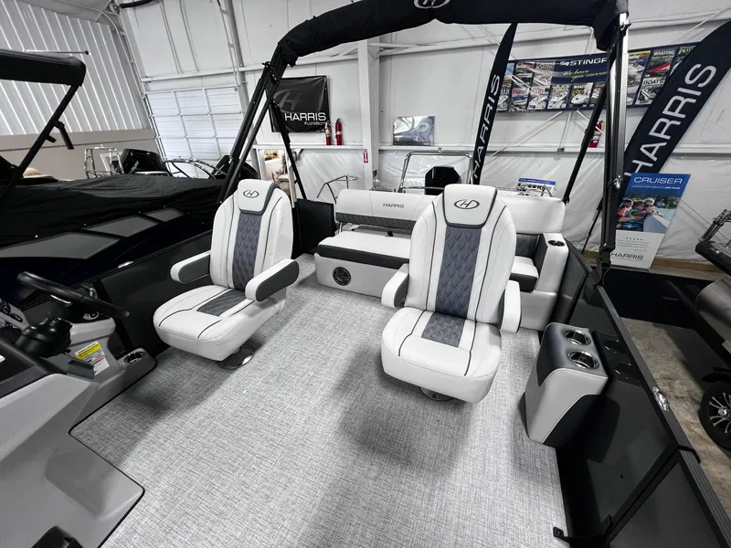 Slide: The Image of 2024 Harris Sunliner 230 boat interior with plush seating and modern design. - 10