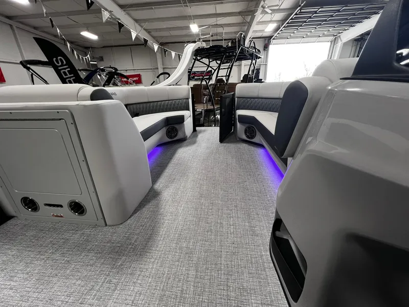 Slide: The Image of 2024 Harris Sunliner 230 interior with modern seating and ambient lighting. - 13