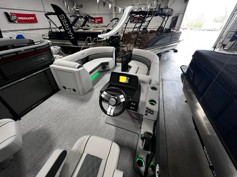 Slide: The Image of 2024 Harris Sunliner 230 pontoon boat interior with modern helm and seating. - 14