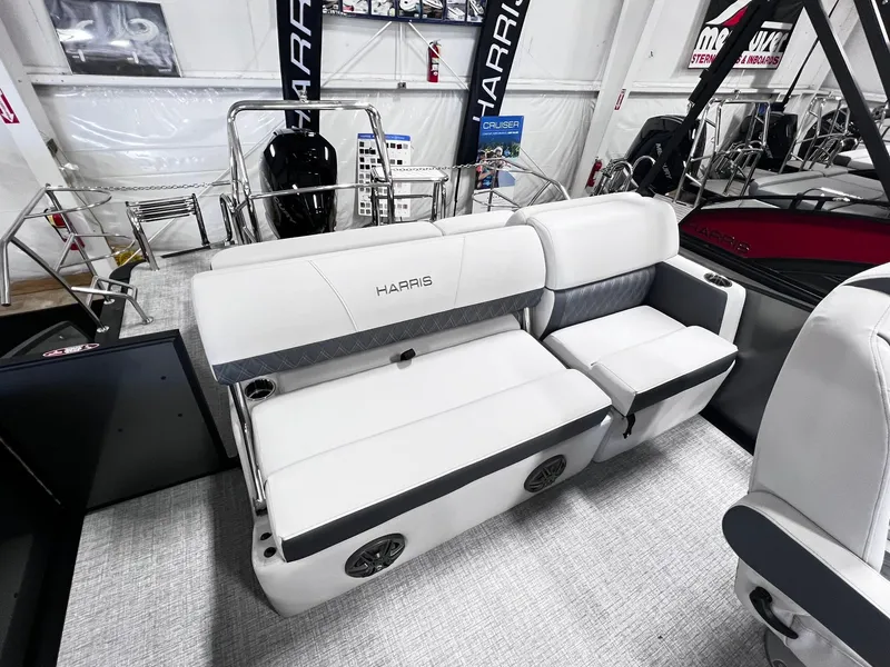 Slide: The Image of 2024 Harris Sunliner 230 boat interior seating with white and gray upholstery. - 15