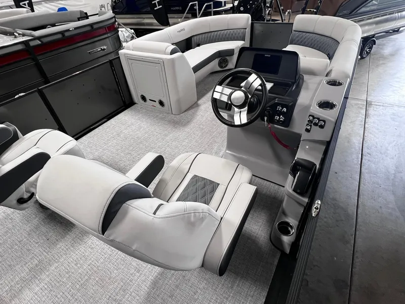 Slide: The Image of 2024 Harris Sunliner 230 boat interior with modern helm and plush seating. - 18